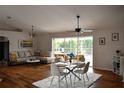 Bright living room with dining area, wood floors, and sliding glass doors at 26187 Argentina Dr, Punta Gorda, FL 33983