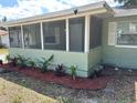Charming home with a screened porch and freshly planted flower bed at 3615 E Grove St, Tampa, FL 33610
