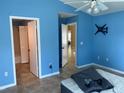 Bright bedroom with tiled floor, ceiling fan, and access to bathroom and walk-in closet at 1210 Etchfield Cir, Brandon, FL 33511