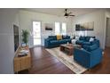 Bright living room with hardwood floors, modern furniture, and ample natural light at 3092 Crowder St, Port Charlotte, FL 33980