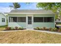 Charming home featuring a cozy screened porch, complemented by well-maintained landscaping and natural light at 514 Fitzhugh Ave, Punta Gorda, FL 33950