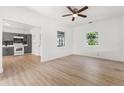 Bright living room boasts hardwood floors and natural light, seamlessly connected to a modern kitchen at 514 Fitzhugh Ave, Punta Gorda, FL 33950
