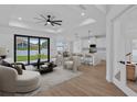 A beautifully staged living room with an open floorplan to a modern kitchen at 2805 Anniston Rd, North Port, FL 34288