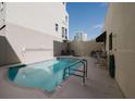 A community in-ground pool with lounge seating, a towel rack, and the depth marked as 5 feet at 235 Cocoanut Ave # 129E, Sarasota, FL 34236