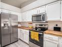 Bright kitchen features stainless steel appliances, white cabinets, and butcher block countertops at 4601 Copper Ln, Plant City, FL 33566