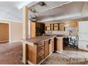 Spacious kitchen with tile floors, center island, and wooden cabinets; renovation needed at 11120 5Th E St, Treasure Island, FL 33706