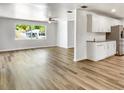 Open-concept living space featuring sleek wood floors, bright lighting and an adjacent kitchen area at 1115 31St W St, Bradenton, FL 34205