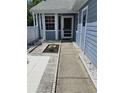 The front door is surrounded by decorative stone and concrete pavers with a tiled entryway at 12627 W Cherrydale Ln, Hudson, FL 34669