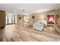 Spacious living room with wood-look tile floors, neutral walls, and access to the front entry at 2436 Deer Trail Ln, Spring Hill, FL 34606