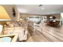 Inviting living room featuring neutral walls, wood-look tile floors and comfortable seating at 2436 Deer Trail Ln, Spring Hill, FL 34606