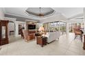 Spacious living room with custom ceiling, built-in shelving, stone fireplace, and bright natural light at 3629 Licata Ct, Punta Gorda, FL 33950