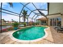 Gorgeous screened-in pool area with lush landscaping and clear water, perfect for relaxing or entertaining at 3629 Licata Ct, Punta Gorda, FL 33950