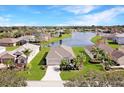 Beautiful aerial view of a home with a manicured lawn and a serene lake view in a friendly neighborhood at 4174 70Th Street E Cir, Palmetto, FL 34221