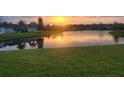 Serene lake at sunset reflecting warm colors, enhancing the natural beauty and tranquility of the surroundings at 4174 70Th Street E Cir, Palmetto, FL 34221