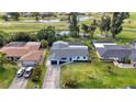 Stunning aerial view of home with a screened lanai overlooking the golf course and pond at 23 Golfview Rd, Rotonda West, FL 33947