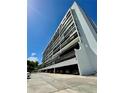 Condo building exterior showing multiple levels, underground parking and clean architectural lines at 3211 W Swann Ave # 408, Tampa, FL 33609