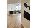 Living room featuring wood floors, neutral decor, stylish furnishings, and a light and airy ambiance at 3211 W Swann Ave # 408, Tampa, FL 33609