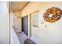 Condo front door with decorative wreath and adjacent storage, adding charm and convenience to the unit at 1111 N Bayshore Blvd # D6, Clearwater, FL 33759