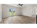 Bright living room featuring new wood-look flooring and sliding glass doors that provide lots of natural light at 3400 Dawson Ln, Punta Gorda, FL 33950
