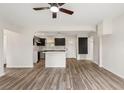 Open living room showcasing new floors, modern fixtures, and a seamless transition into the updated kitchen at 3400 Dawson Ln, Punta Gorda, FL 33950