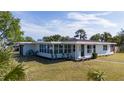 Well-maintained single-story home with a tidy front yard and meticulous landscaping at 520 Baywood S Dr, Dunedin, FL 34698