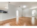 Open-concept living room features wood floors and plenty of natural light at 13516 Copper Head Dr, Riverview, FL 33569