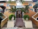 Inviting building entrance with tiled stairs, potted plants, and decorative ironwork at 200 4Th S Ave # 231, St Petersburg, FL 33701