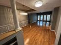 Open living area with hardwood floors, decorative columns, and glass doors to the outside at 200 4Th S Ave # 231, St Petersburg, FL 33701