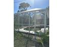 Screened-in pool with ladder and concrete edging at 21285 Peachland Blvd, Port Charlotte, FL 33954