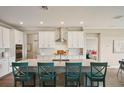 Modern kitchen with white cabinetry, stainless steel appliances and a large island with seating at 8364 Capstone Ranch Dr, New Port Richey, FL 34655