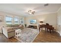 Bright living room featuring hardwood floors, a ceiling fan, and a water view at 8364 Capstone Ranch Dr, New Port Richey, FL 34655
