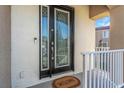 Elegant front door with decorative glass, welcome mat, and a security system at 7327 Brightwaters Ct, New Port Richey, FL 34652