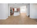 Spacious open-plan kitchen and living area with tile flooring and modern design at 7327 Brightwaters Ct, New Port Richey, FL 34652