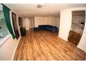 Open-concept living room with vinyl floors and access to the adjacent kitchen at 8006 Beaver Creek Loop, Hudson, FL 34667