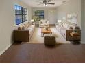 Bright living room featuring large windows, hardwood floors, and comfortable beige furnishings at 701 71St N Ave, St Petersburg, FL 33702