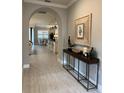 Open-concept foyer showcasing views of dining and living areas, featuring an arched doorway at 1427 Hyssop Loop, North Port, FL 34289
