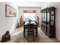 Formal dining area featuring a chandelier, statues, and large display cabinet perfect for dinner parties at 25301 Longmeadow Dr, Punta Gorda, FL 33955