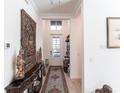 Inviting entry hallway with high ceilings, neutral walls, and decorative accents at 25301 Longmeadow Dr, Punta Gorda, FL 33955