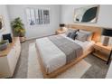 Cozy bedroom features a plush bed, stylish mirror, and natural light at 4914 Trinidad Dr, Land O Lakes, FL 34639