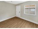 Empty bedroom with wood-look floors, a ceiling fan, and a bright window, perfect for customization at 961 Charlotte Ave, Sarasota, FL 34237