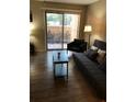 Cozy living room with a sliding glass door and tile flooring at 8653 Fancy Finch Dr # 102, Tampa, FL 33614
