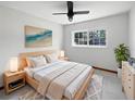 Cozy bedroom featuring a comfortable bed, modern ceiling fan, and a bright window at 11114 N 21St St, Tampa, FL 33612
