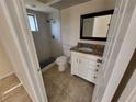 Stylish bathroom featuring a walk-in shower with stone floors and a granite-topped vanity at 89 Mark Twain Ln, Rotonda West, FL 33947