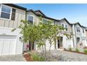 Street view of new townhomes with brick-paved driveways and well-maintained landscaping at 7270 Deer Valley Cir, Tampa, FL 33635