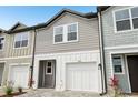Modern townhome with a one-car garage, paver driveway, and neutral color scheme at 7272 Deer Valley Circle, Tampa, FL 33635