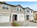 Attractive townhomes with paver driveway, one car garage, and manicured landscaping at 7272 Deer Valley Circle, Tampa, FL 33635