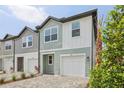 Attractive townhome with a one-car garage and well-maintained landscaping at 7274 Deer Valley Cir, Tampa, FL 33635