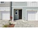 Close up of townhome entrance featuring a dark front door and paved pathway at 7294 Deer Valley Cir, Tampa, FL 33635