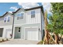 Charming two-story townhome featuring light blue siding and tropical landscaping at 7294 Deer Valley Cir, Tampa, FL 33635