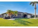 Well-kept single-story home featuring a lush lawn and lovely landscaping at 5202 Forbes Ter, Port Charlotte, FL 33981